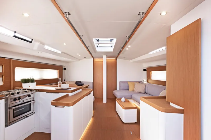 Slide: The Image of Luxurious interior of 2026 Beneteau First 53 yacht with modern kitchen and cozy seating area. - 15