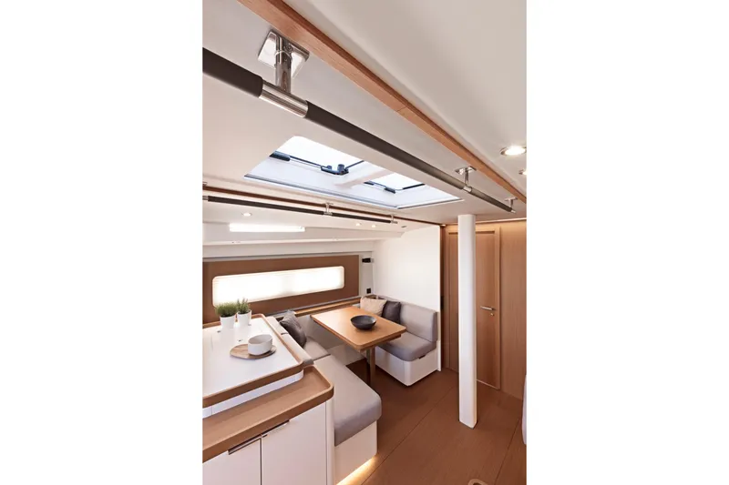 Slide: The Image of Luxurious interior of 2026 Beneteau First 53 yacht with modern dining area and skylight. - 18