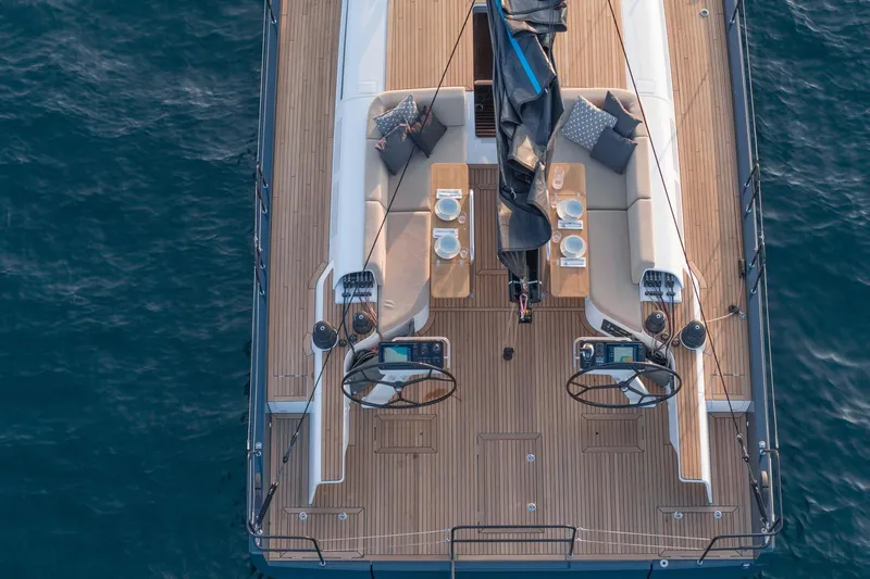 Slide: The Image of Aerial view of 2026 Beneteau First 53 yacht deck with elegant seating and dining setup. - 2