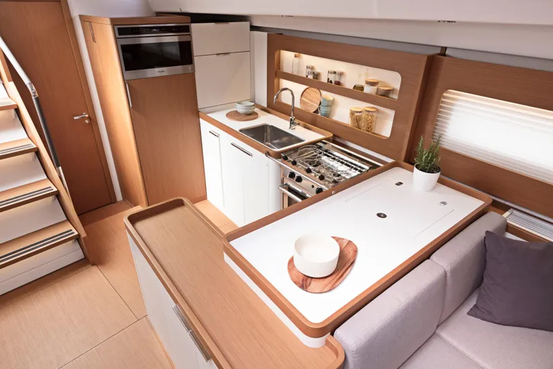 Slide: The Image of Modern kitchen interior of 2026 Beneteau First 53 yacht, featuring sleek design and wooden accents. - 22