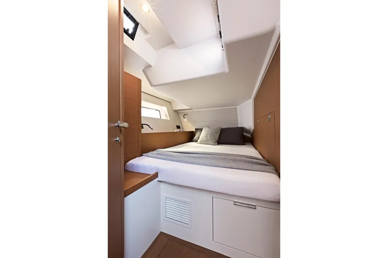 Slide: The Image of Luxurious cabin interior of 2026 Beneteau First 53 yacht, featuring cozy bedding and modern design. - 23