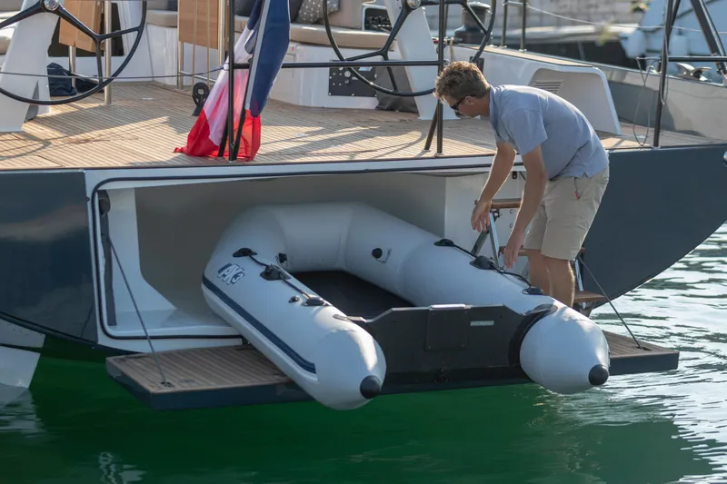 Slide: The Image of Man handling inflatable boat on Beneteau First 53 yacht, 2026 model. - 26