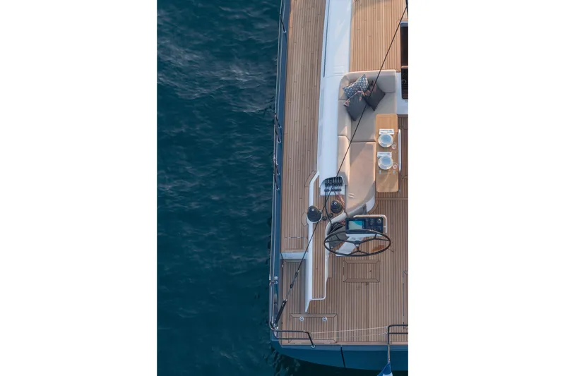 Slide: The Image of Aerial view of 2026 Beneteau First 53 yacht deck with seating and dining area. - 32