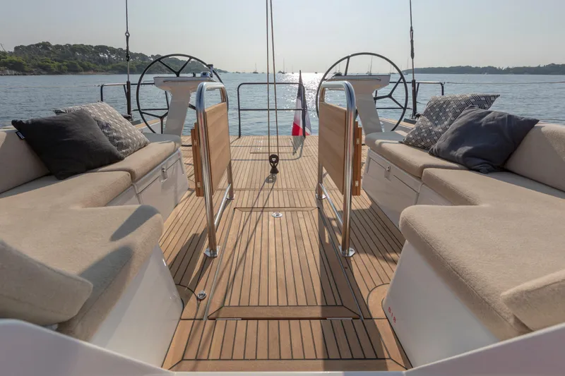 Slide: The Image of Luxurious 2026 Beneteau First 53 yacht deck with plush seating and dual steering wheels. - 35