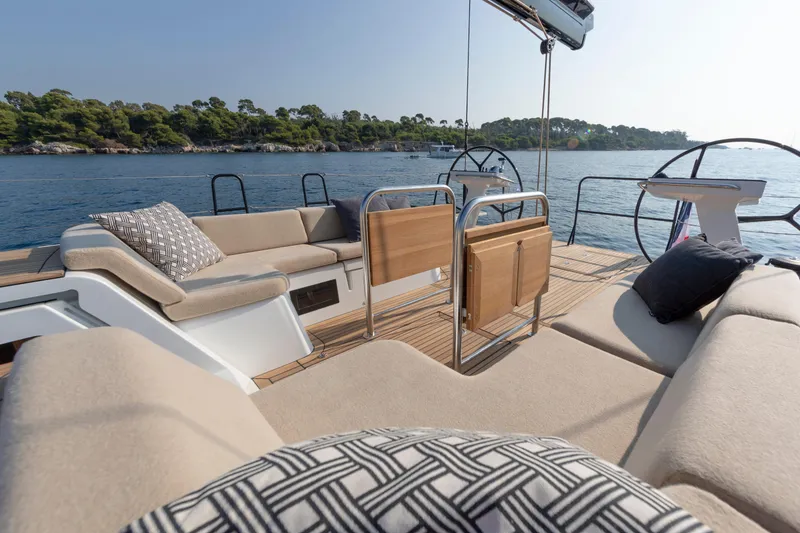 Slide: The Image of Luxurious 2026 Beneteau First 53 yacht deck with plush seating and scenic ocean view. - 36
