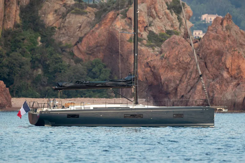 Slide: The Image of 2026 Beneteau First 53 yacht sailing near rocky coastline. - 42