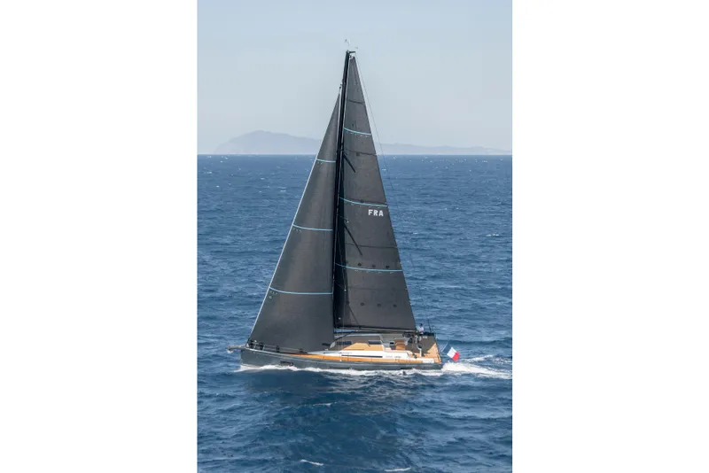 Slide: The Image of Sailing yacht Beneteau First 53 (2026) navigating open sea with black sails. - 44