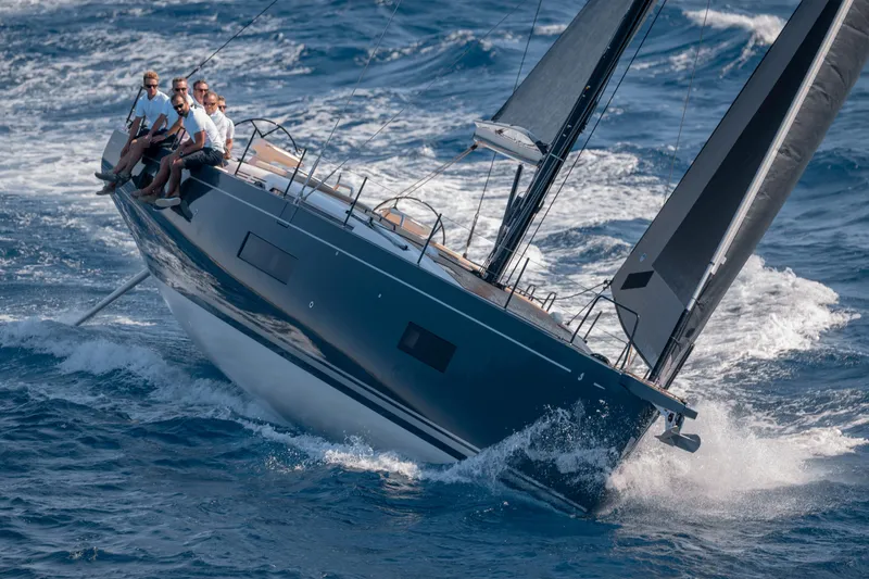Slide: The Image of 2026 Beneteau First 53 sailing yacht navigating through ocean waves with crew on deck. - 46