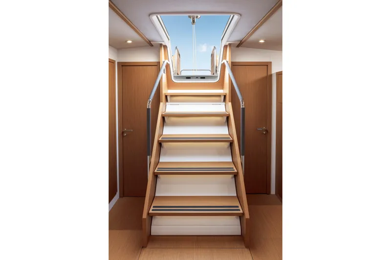 Slide: The Image of Interior stairs of 2026 Beneteau First 53 yacht, leading to deck with wooden finish. - 6
