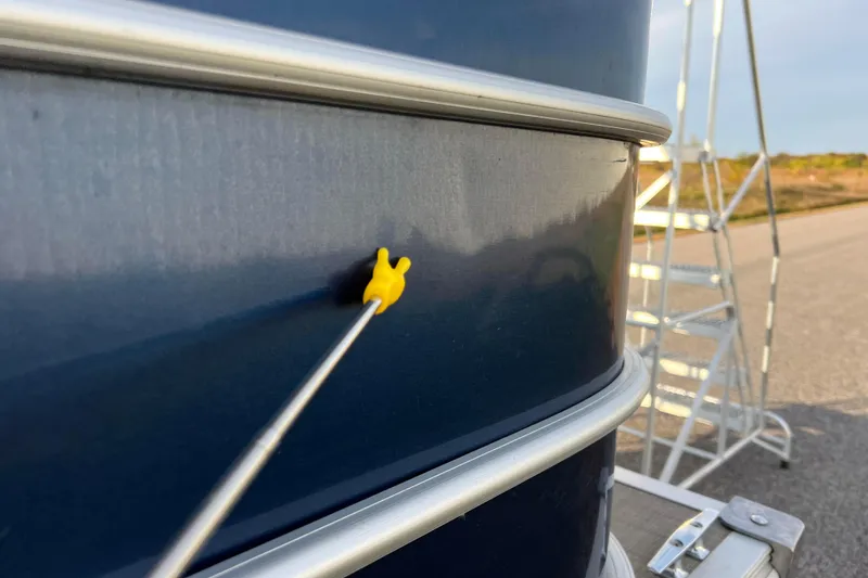 Slide: The Image of Close-up of a 2015 Sylvan Mirage Fish 8522 Party Fish LE boat exterior with a yellow pointer. - 17