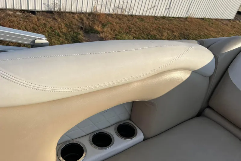 Slide: The Image of 2015 Sylvan Mirage Fish 8522 Party Fish LE boat interior with beige seating and cup holders. - 41