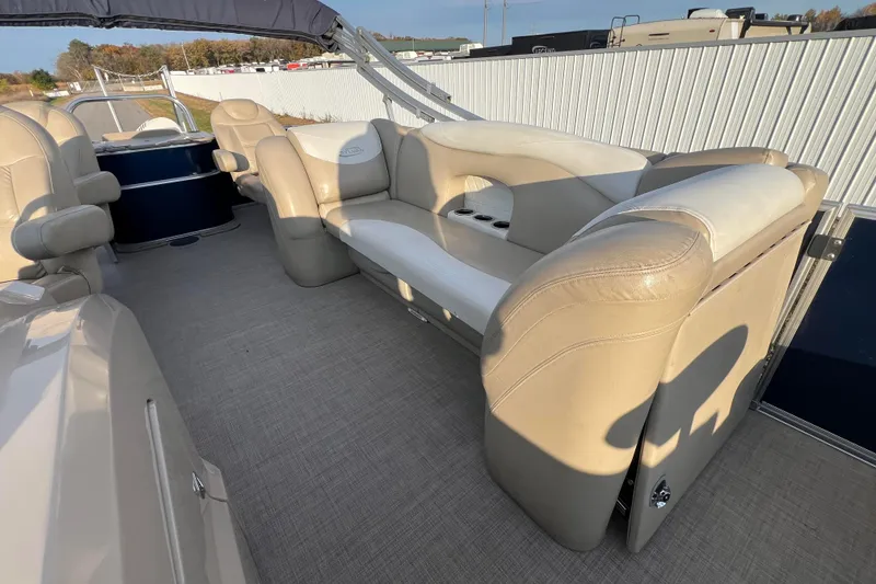 Slide: The Image of 2015 Sylvan Mirage Fish 8522 Party Fish LE interior with beige seating and cup holders. - 47