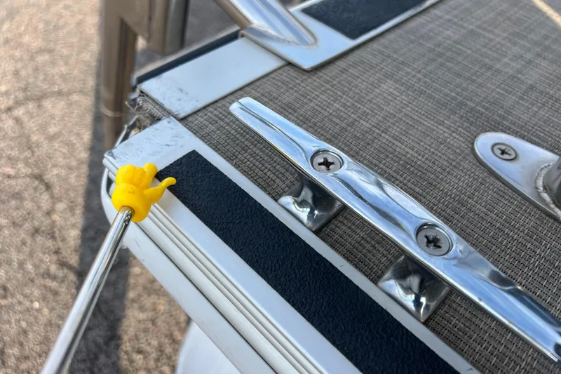 Slide: The Image of Close-up of Sylvan Mirage Fish 8522 Party Fish LE boat detail, featuring metal fixtures and textured surface. - 53