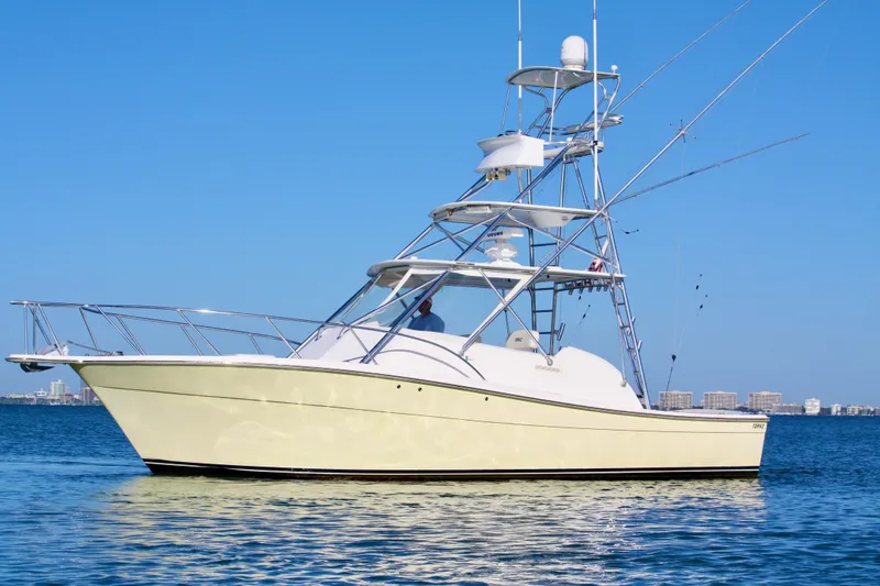 The Image of 2006 Topaz Express Cruiser on calm water with clear blue sky background. - 0