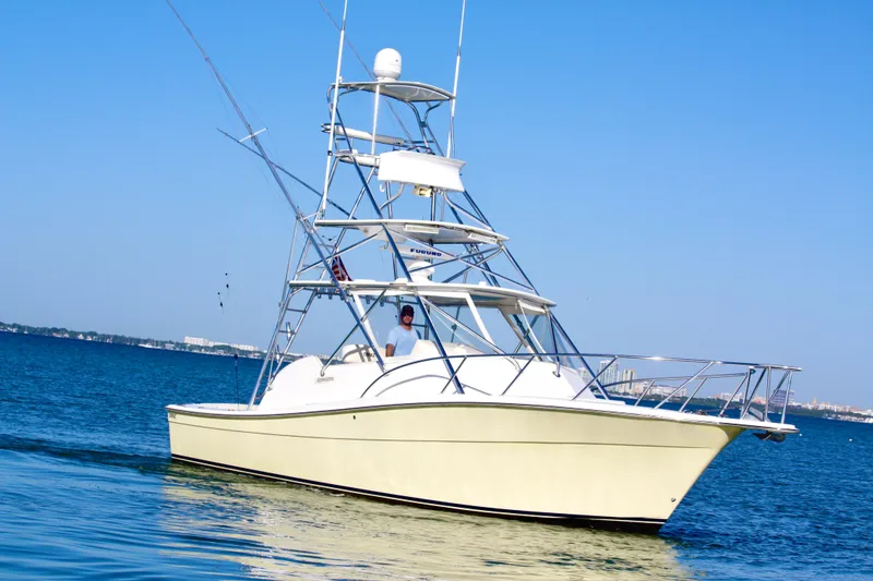 Slide: The Image of 2006 Topaz Express Cruiser on calm blue water under clear sky. - 1