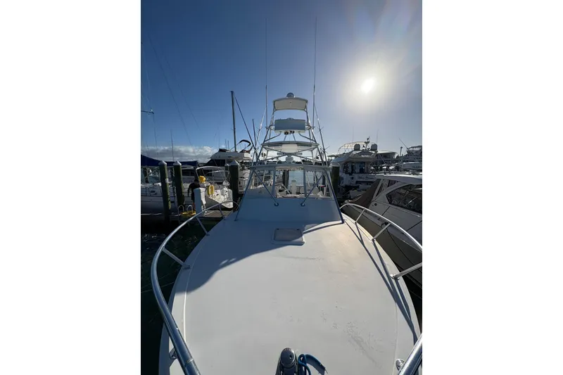 Slide: The Image of 2006 Topaz Express Cruiser docked under a bright sunlit sky. - 14