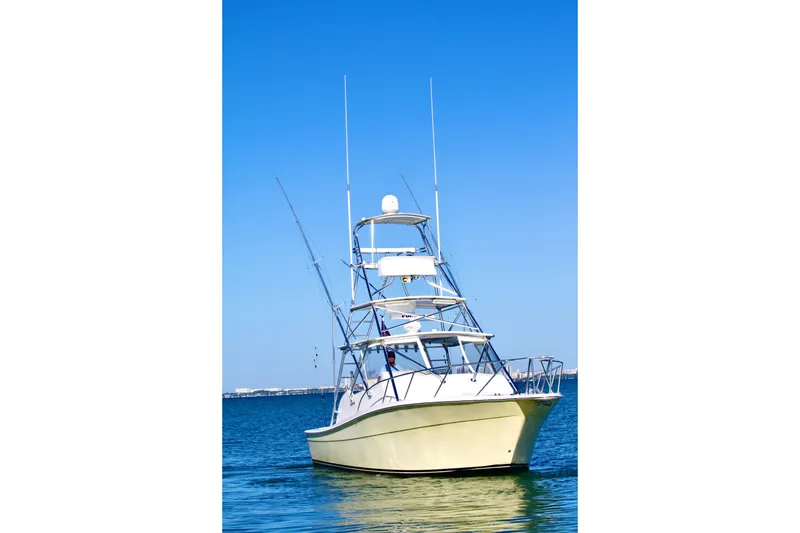 Slide: The Image of 2006 Topaz Express Cruiser boat on calm blue water under clear sky. - 4