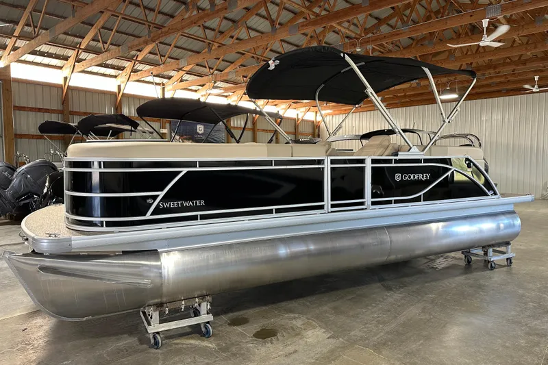 The Image of 2026 Godfrey SWEETWATER 2286 SB pontoon boat in a warehouse setting. - 1