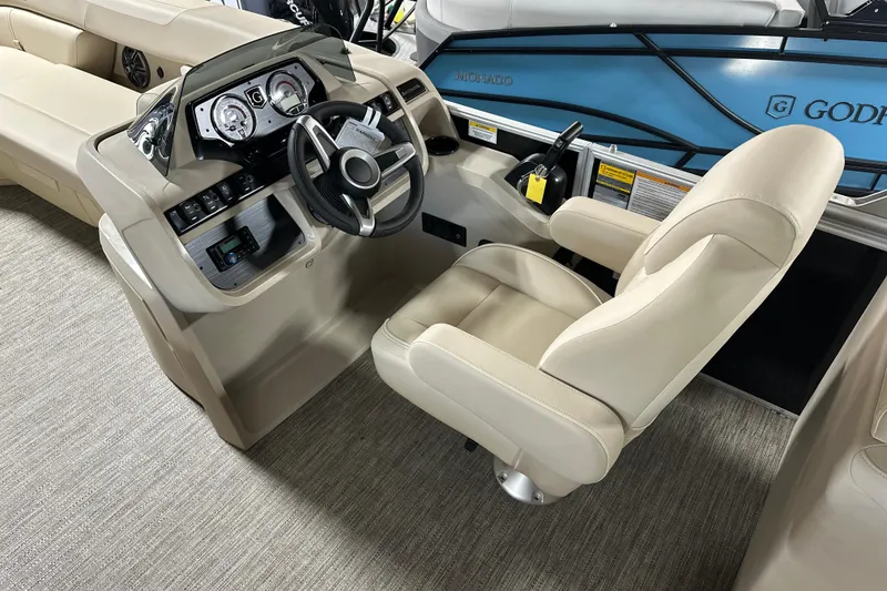Slide: The Image of Interior of 2026 Godfrey SWEETWATER 2286 SB boat with steering console and captain's chair. - 11