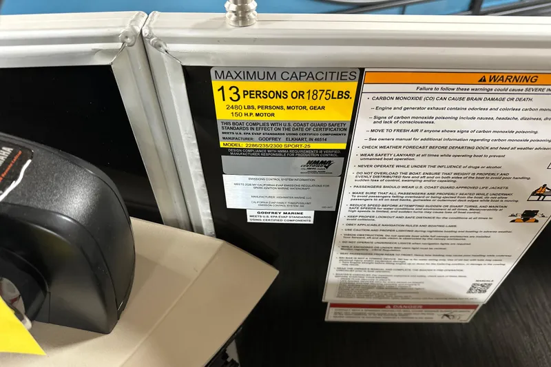 Slide: The Image of Capacity and safety warnings on 2026 Godfrey SWEETWATER 2286 SB boat, highlighting weight and passenger limits. - 13