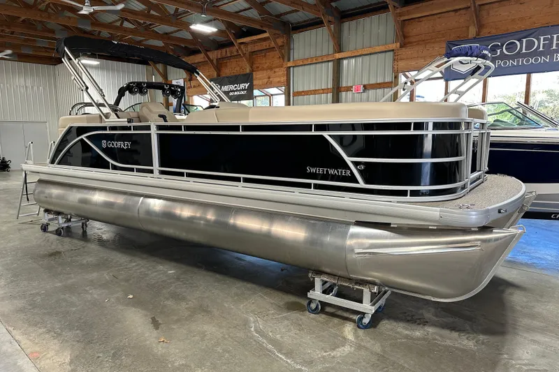 Slide: The Image of 2026 Godfrey SWEETWATER 2286 SB pontoon boat in a showroom setting. - 4