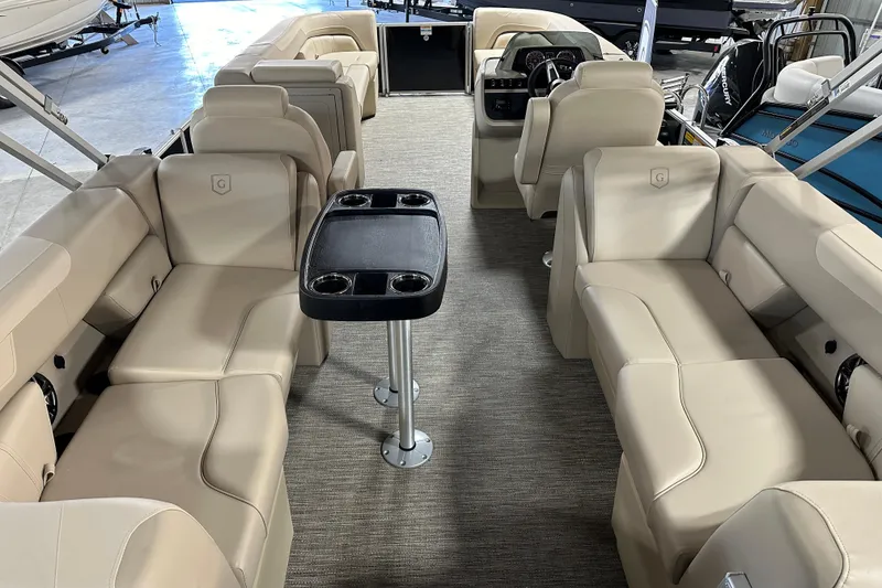 Slide: The Image of 2026 Godfrey SWEETWATER 2286 SB pontoon boat interior with beige seating and central table. - 5