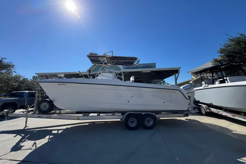 Slide: The Image of 2005 Glacier Bay 260 Canyon Runner boat on trailer under clear blue sky. - 1