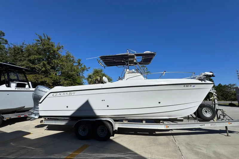 Slide: The Image of 2005 Glacier Bay 260 Canyon Runner boat on trailer under clear blue sky. - 10