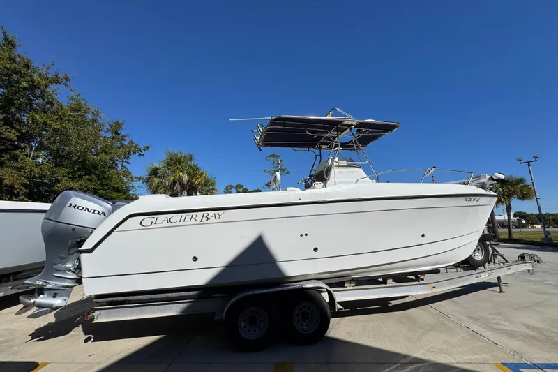 Slide: The Image of 2005 Glacier Bay 260 Canyon Runner boat on trailer under clear blue sky. - 11