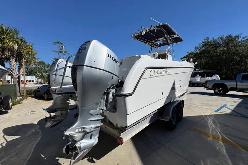 Slide: The Image of 2005 Glacier Bay 260 Canyon Runner boat with dual Honda outboard motors on a trailer. - 12