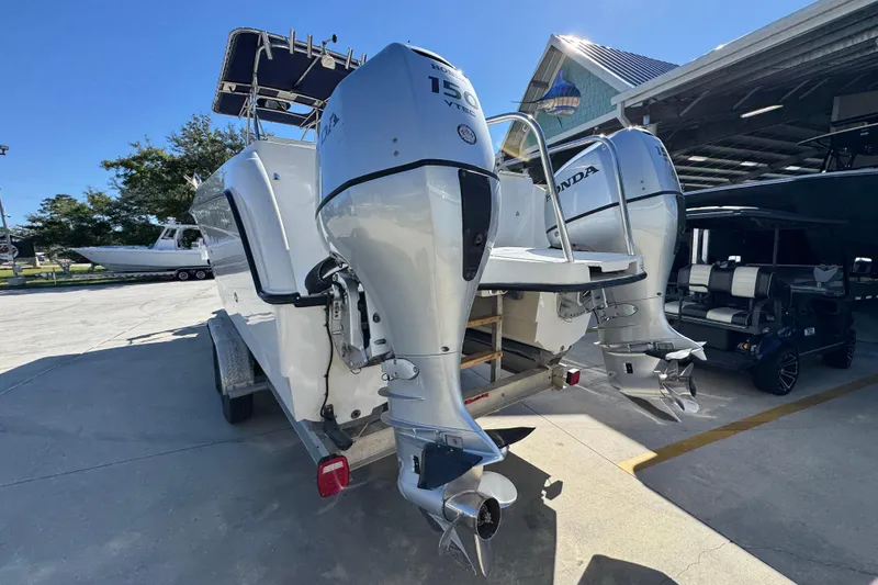 Slide: The Image of 2005 Glacier Bay 260 Canyon Runner with dual Honda outboard motors in a sunny marina. - 15