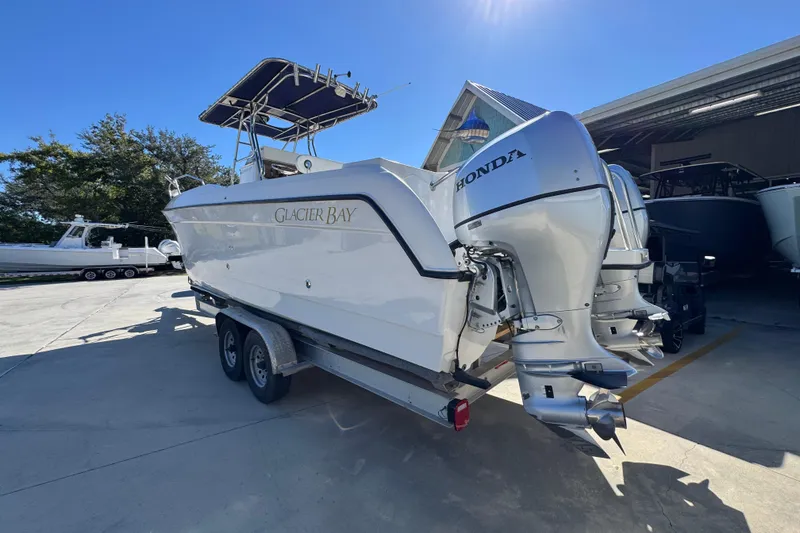 Slide: The Image of 2005 Glacier Bay 260 Canyon Runner boat with dual Honda outboard engines on a trailer. - 16