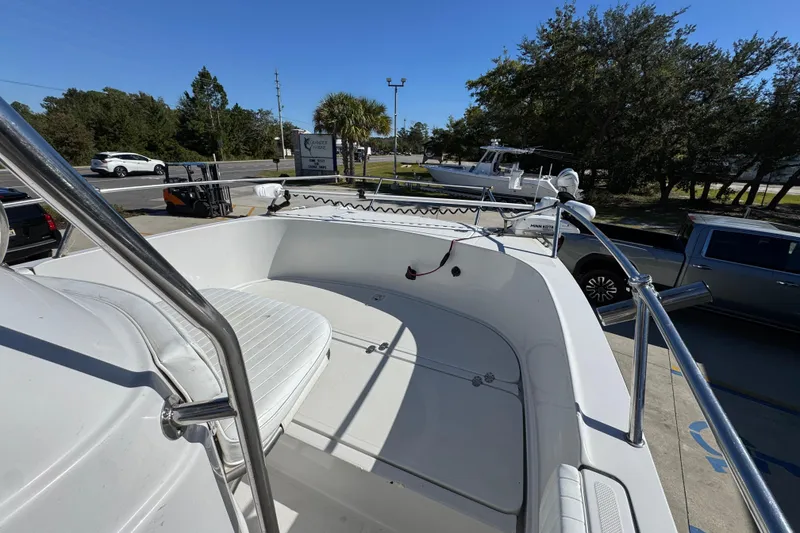 Slide: The Image of 2005 Glacier Bay 260 Canyon Runner boat, white deck, parked outdoors under clear sky. - 18