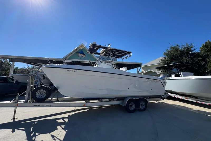 Slide: The Image of 2005 Glacier Bay 260 Canyon Runner boat on trailer under clear blue sky. - 2