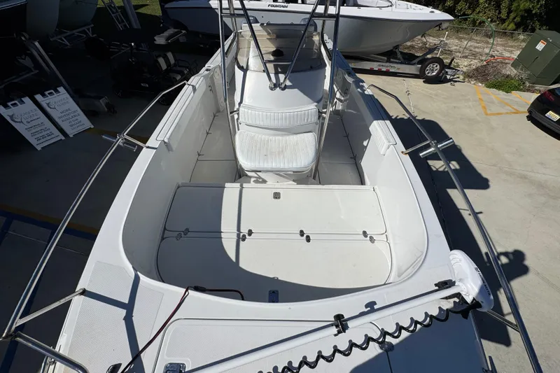 Slide: The Image of 2005 Glacier Bay 260 Canyon Runner boat, spacious deck, white seating, docked outdoors. - 21