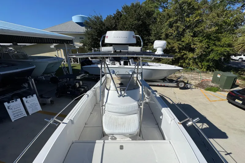 Slide: The Image of 2005 Glacier Bay 260 Canyon Runner boat docked at marina, surrounded by trees and other boats. - 22