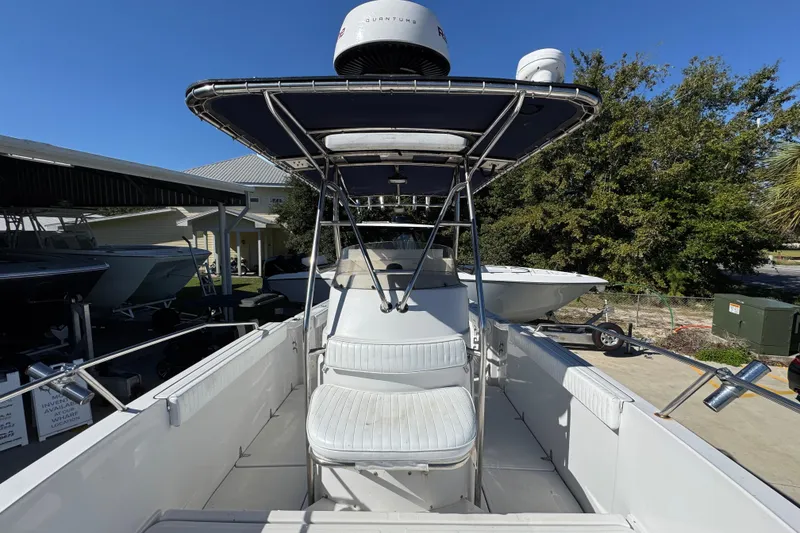 Slide: The Image of 2005 Glacier Bay 260 Canyon Runner boat with T-top and seating, docked outdoors. - 23