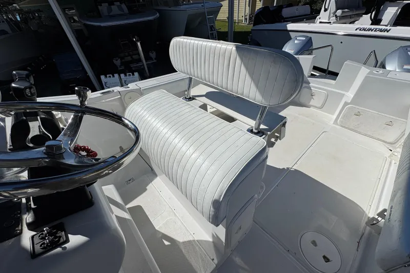 Slide: The Image of 2005 Glacier Bay 260 Canyon Runner boat interior with steering wheel and seating. - 26