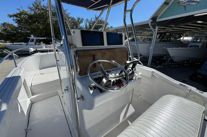 Slide: The Image of 2005 Glacier Bay 260 Canyon Runner boat interior with steering console and seating. - 27