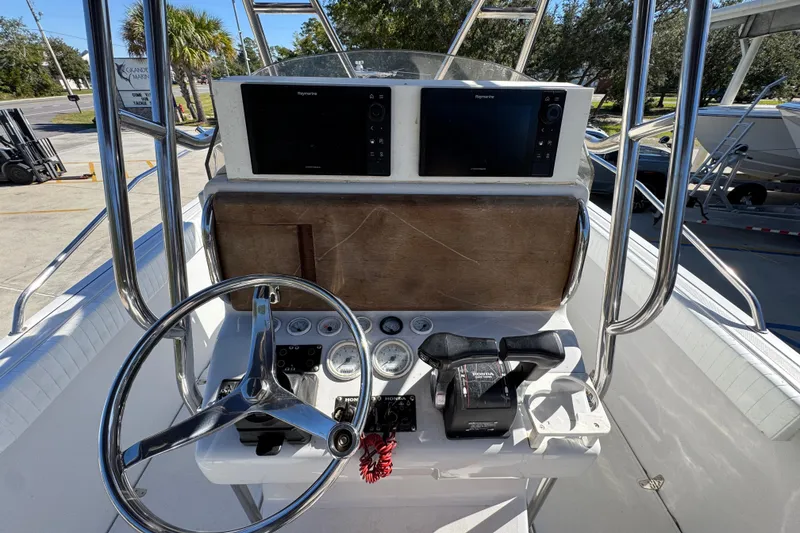 Slide: The Image of 2005 Glacier Bay 260 Canyon Runner boat helm with dual Raymarine displays and Honda controls. - 28
