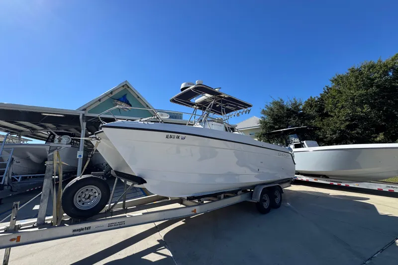 Slide: The Image of 2005 Glacier Bay 260 Canyon Runner boat on trailer under clear blue sky. - 3