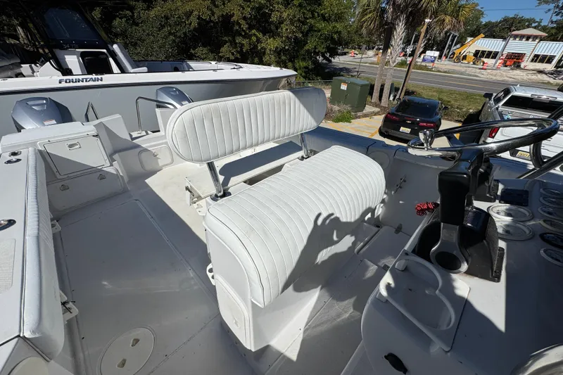 Slide: The Image of 2005 Glacier Bay 260 Canyon Runner boat interior with white seating and steering wheel. - 30