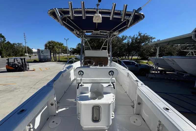 Slide: The Image of 2005 Glacier Bay 260 Canyon Runner boat with T-top, docked outdoors on a sunny day. - 32