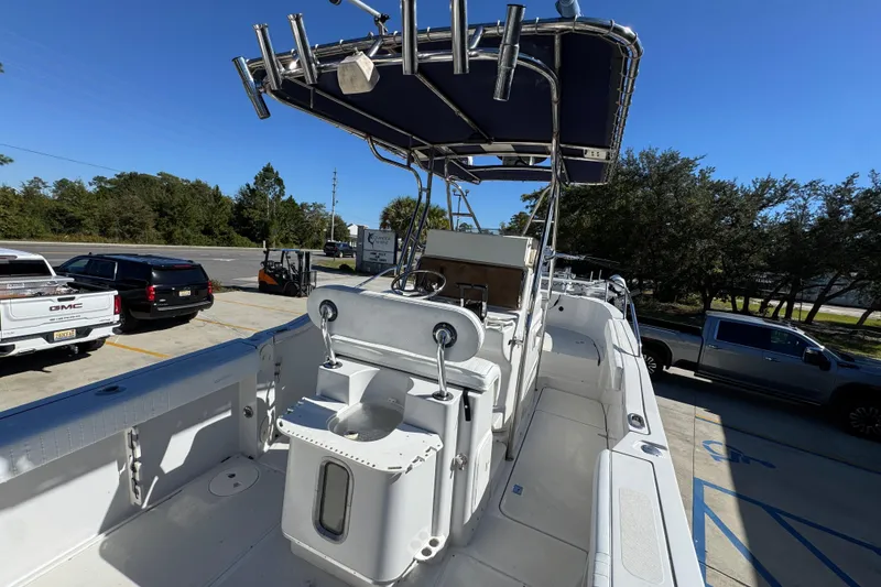 Slide: The Image of 2005 Glacier Bay 260 Canyon Runner boat with T-top, parked in a lot under clear blue sky. - 33