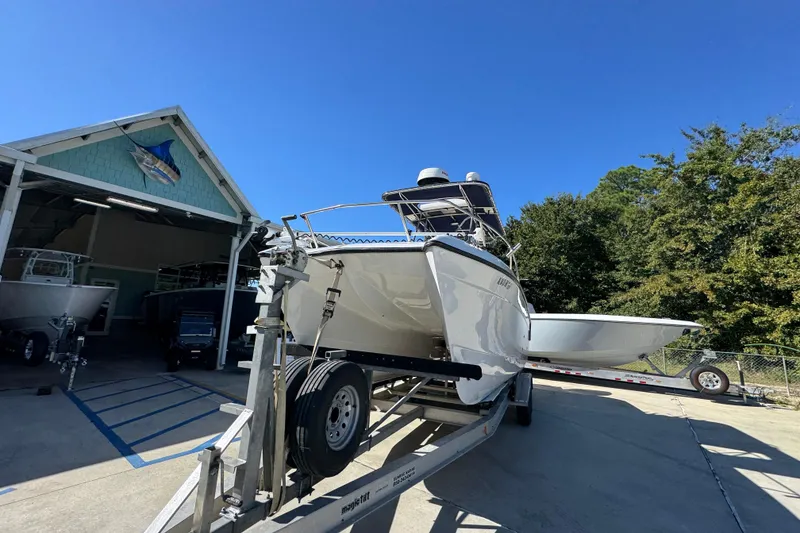 Slide: The Image of 2005 Glacier Bay 260 Canyon Runner boat on trailer outside a boathouse. - 5