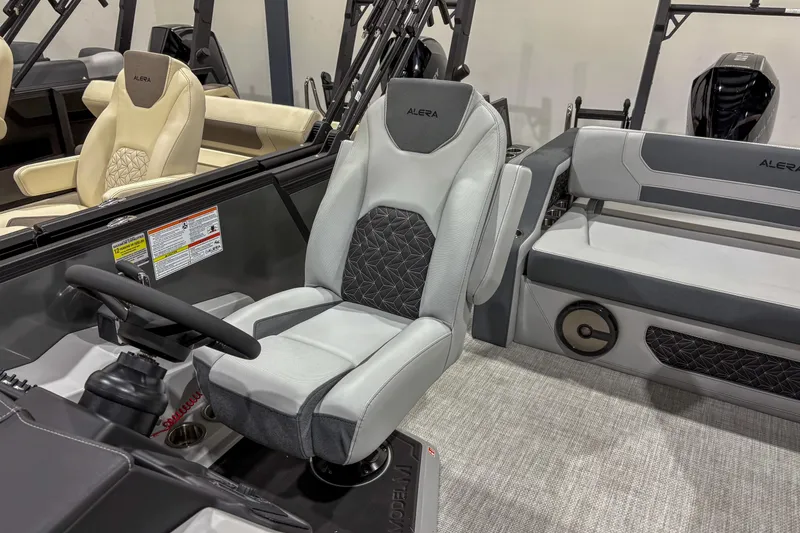 Slide: The Image of 2026 Alera M23L boat interior with modern seating and steering console. - 5
