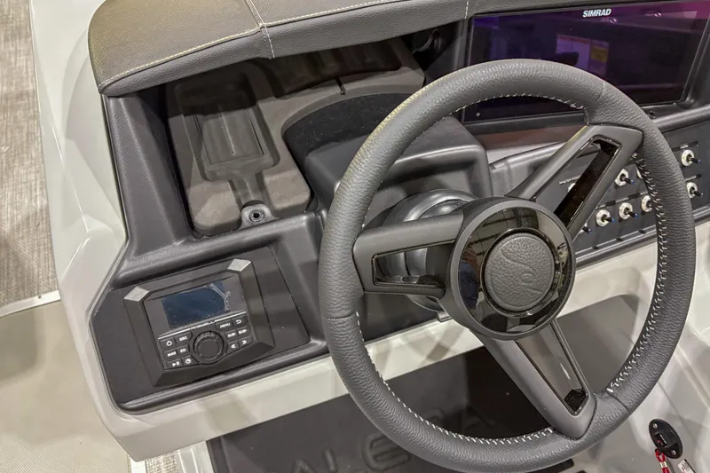 Slide: The Image of Steering wheel and dashboard of 2026 Alera M23L boat with control panel. - 7