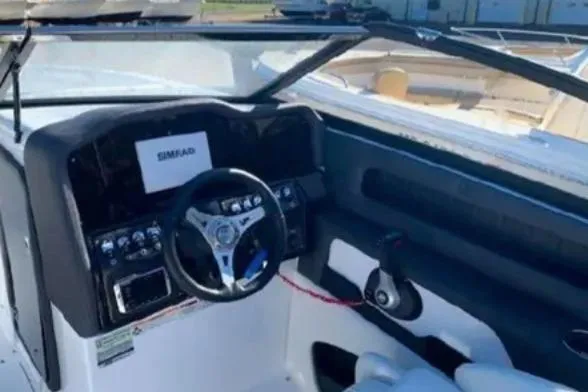 Slide: The Image of 2019 Rinker Q3 OB boat dashboard with steering wheel and controls. - 6