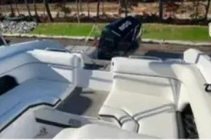 Slide: The Image of 2019 Rinker Q3 OB boat with spacious white seating and outdoor view. - 7