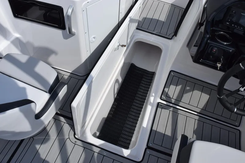 Slide: The Image of 2026 Yamaha Boats 195S interior with open storage compartment and seating. - 17